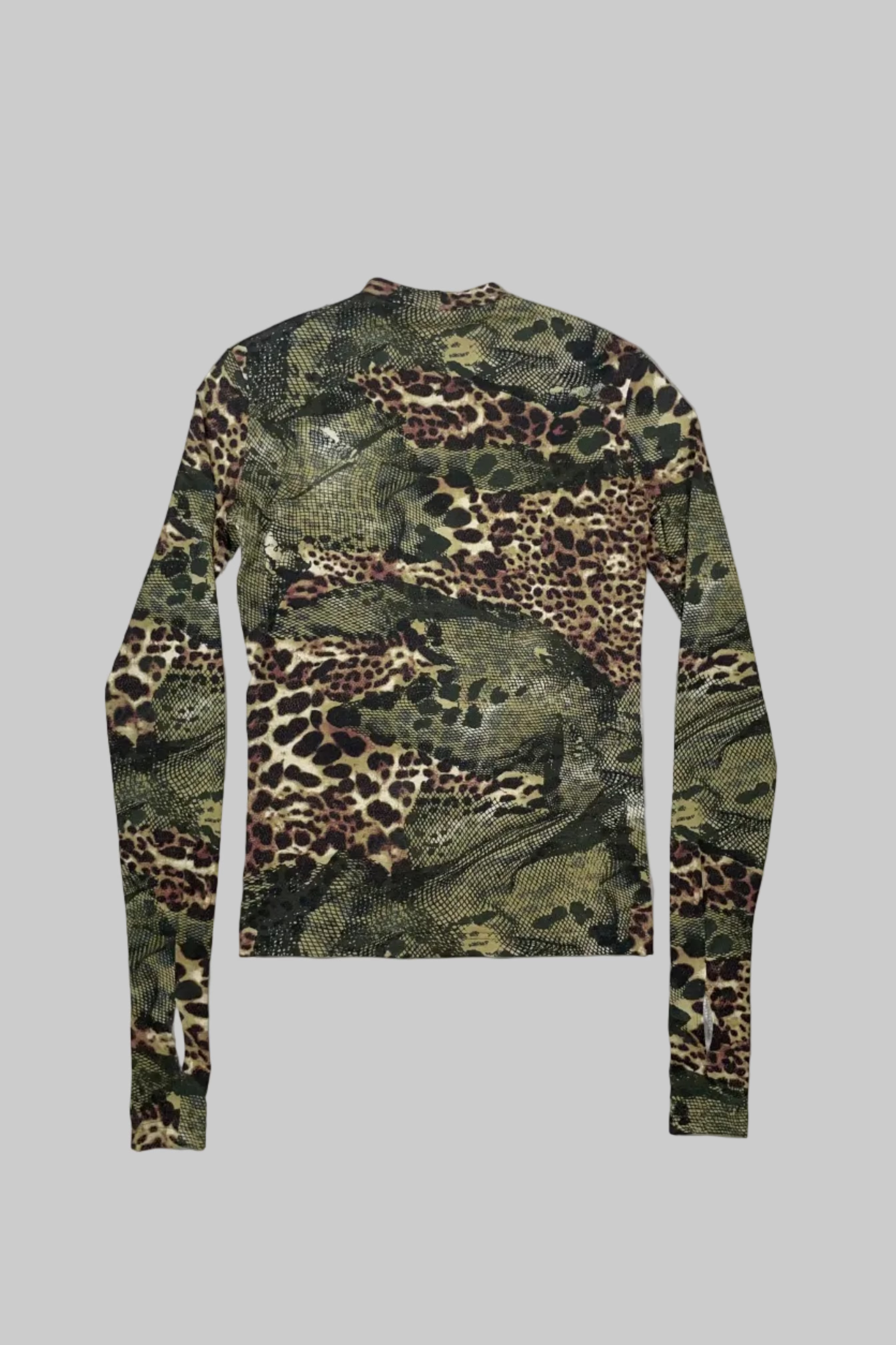 A long-sleeve crewneck shirt featuring an all-over mixed animal print pattern with leopard spots, snakeskin texture, and camouflage elements in green, brown, black, and beige, laid flat on a white wooden plank background.