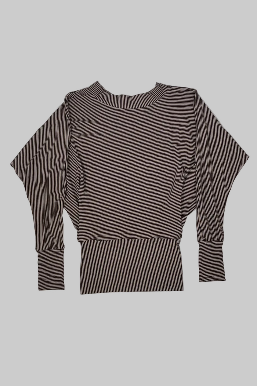 A brown and white striped long-sleeve knit top with a crew neck and batwing sleeves, laid flat on a white wooden plank background.