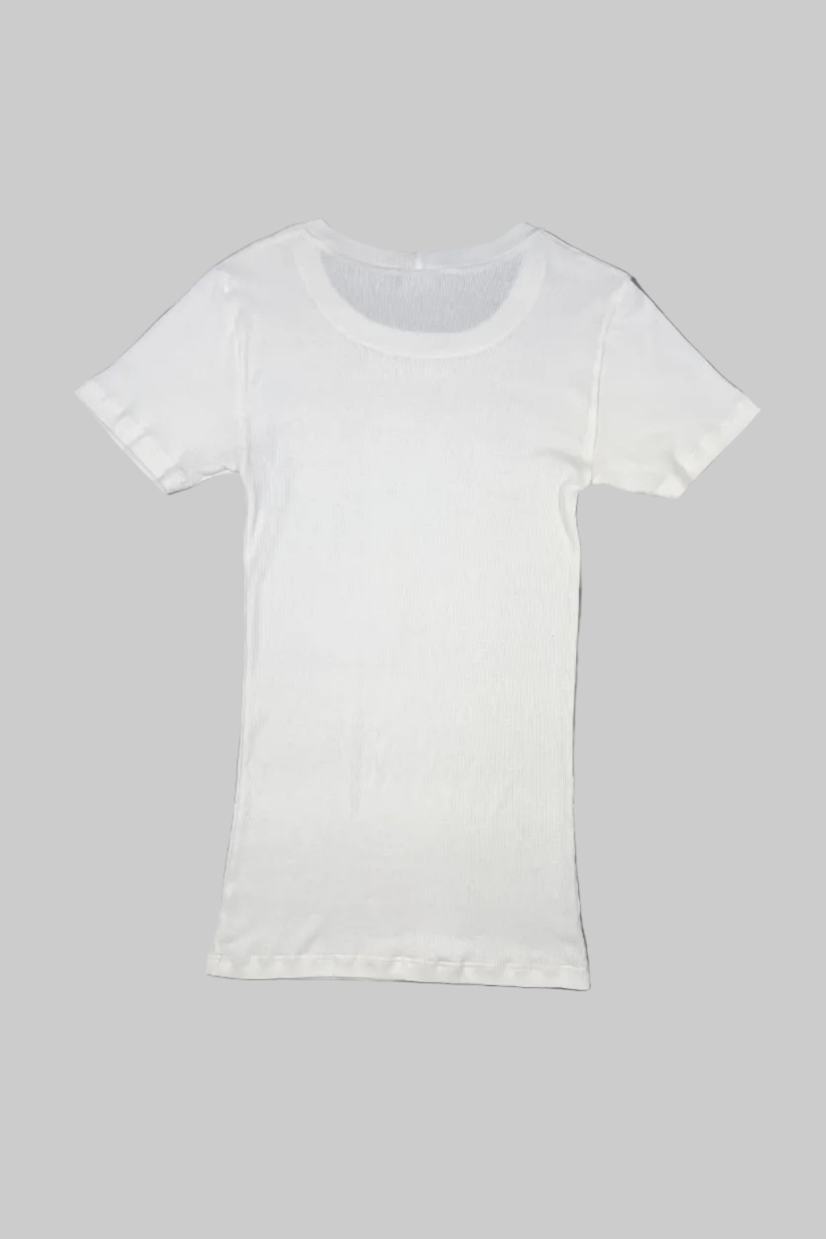 A plain white short-sleeve crewneck t-shirt laid flat on a gray painted wooden floor.