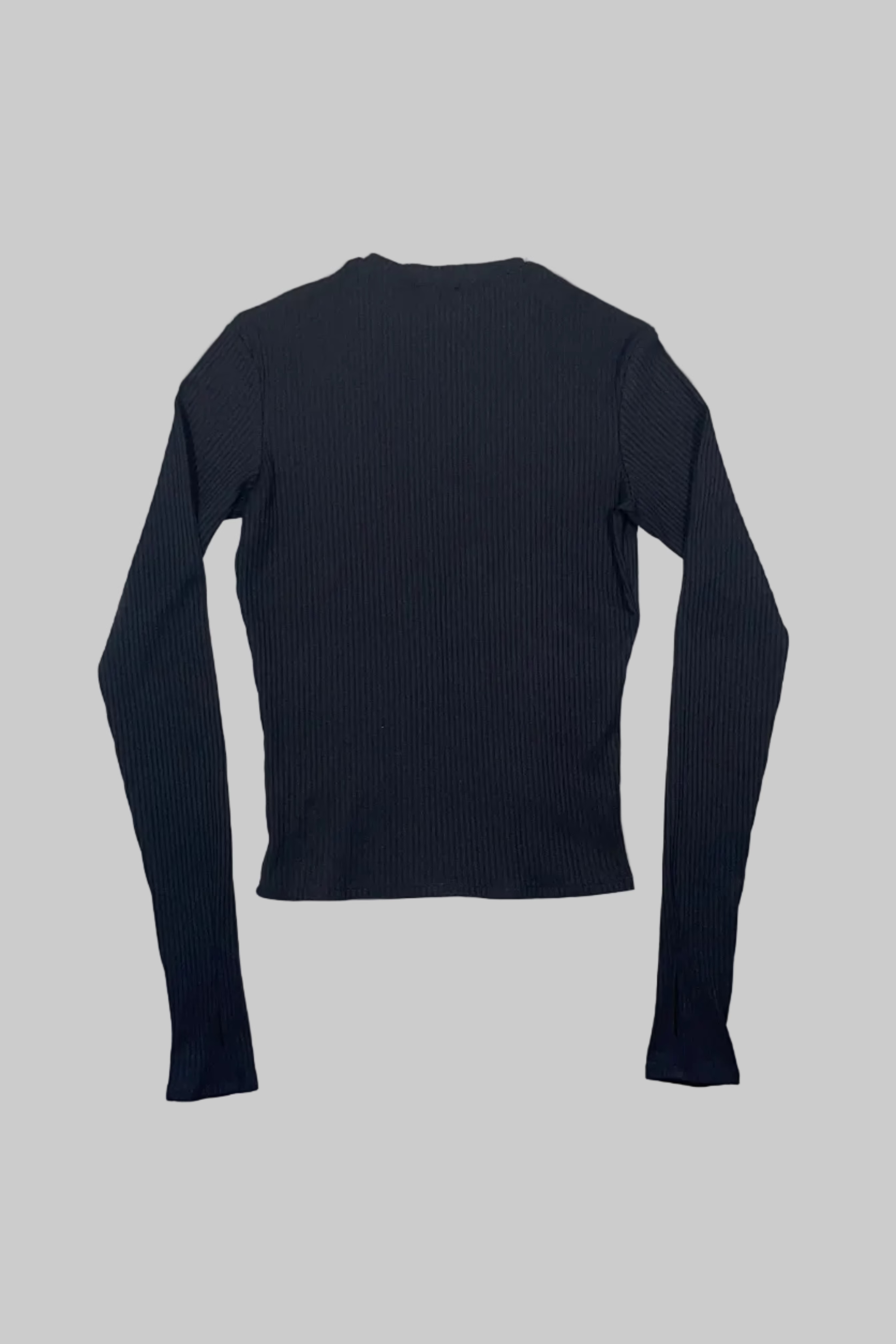 A black ribbed long-sleeve top laid flat on a white wooden plank surface.