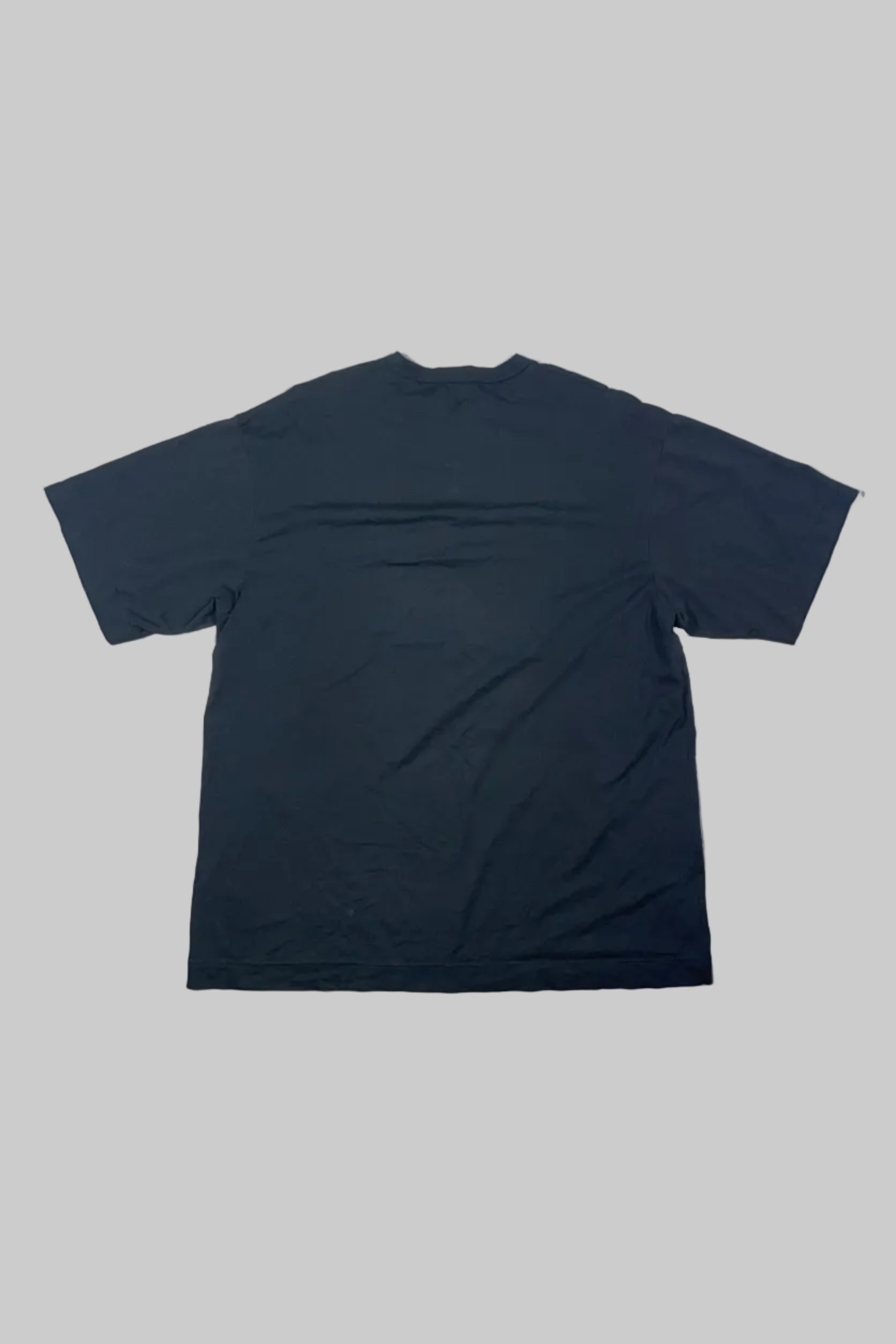 A dark navy blue short-sleeve t-shirt laid flat on a white wooden plank floor.