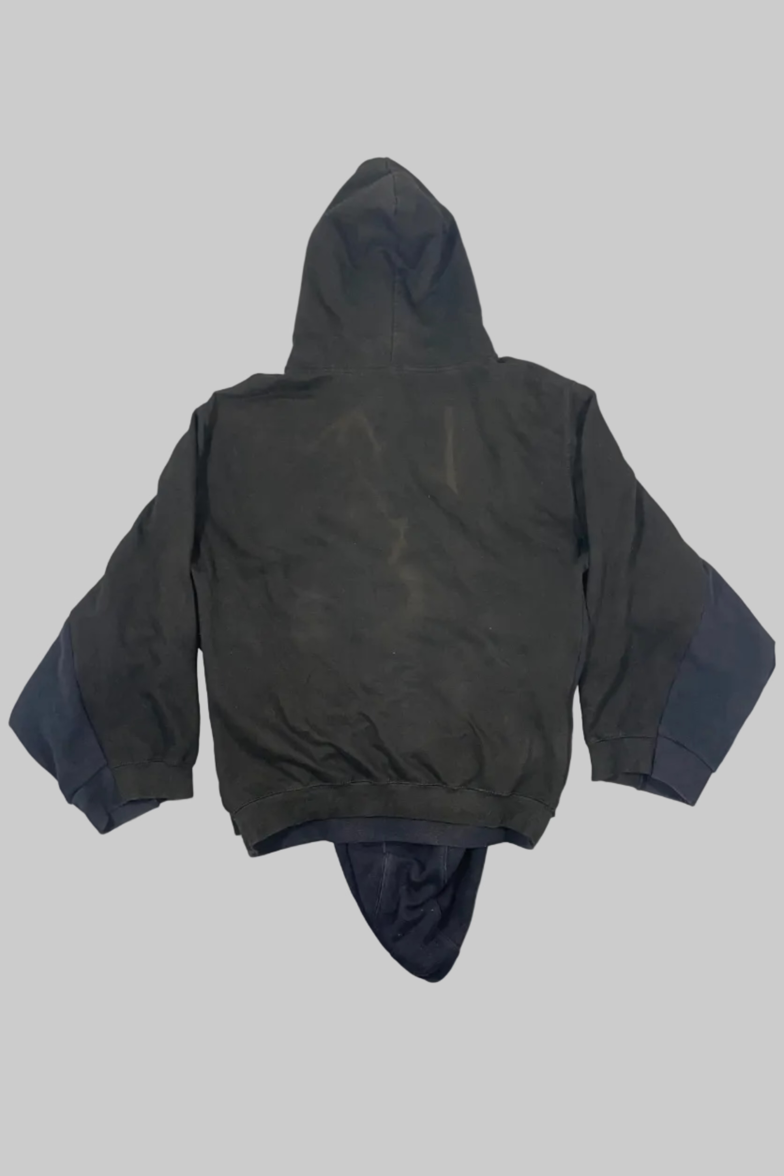 A dark olive green hooded jacket with contrasting dark blue cuffs and a dark blue hood lining, laid flat on a white wooden plank background.