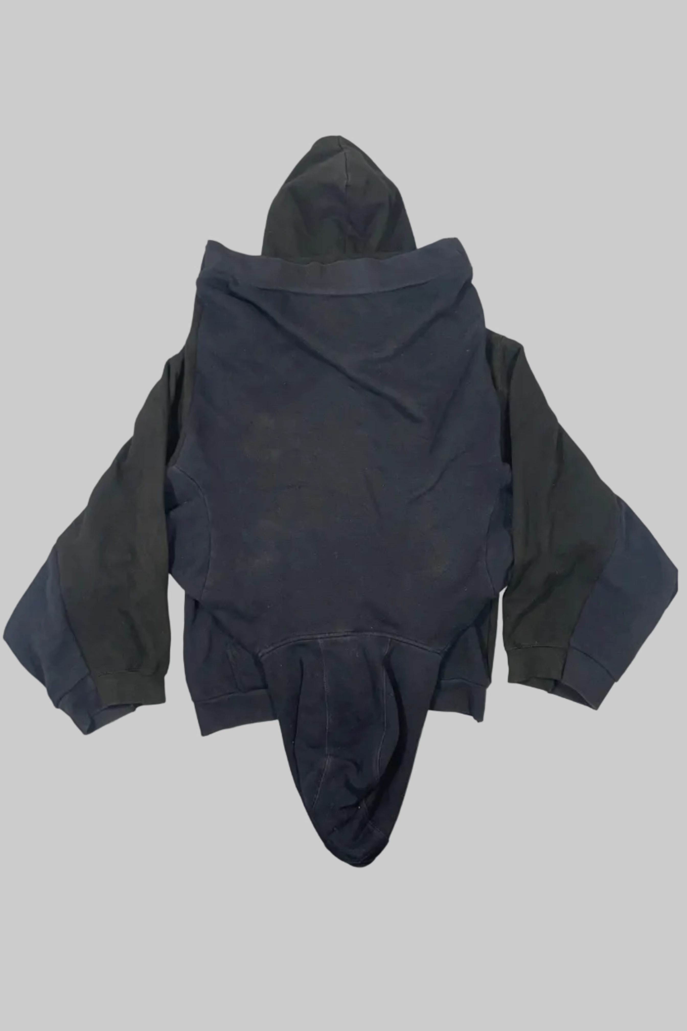 A dark gray hooded jumpsuit or bodysuit with long sleeves and a unique split leg design, laid flat on a white wooden plank background.